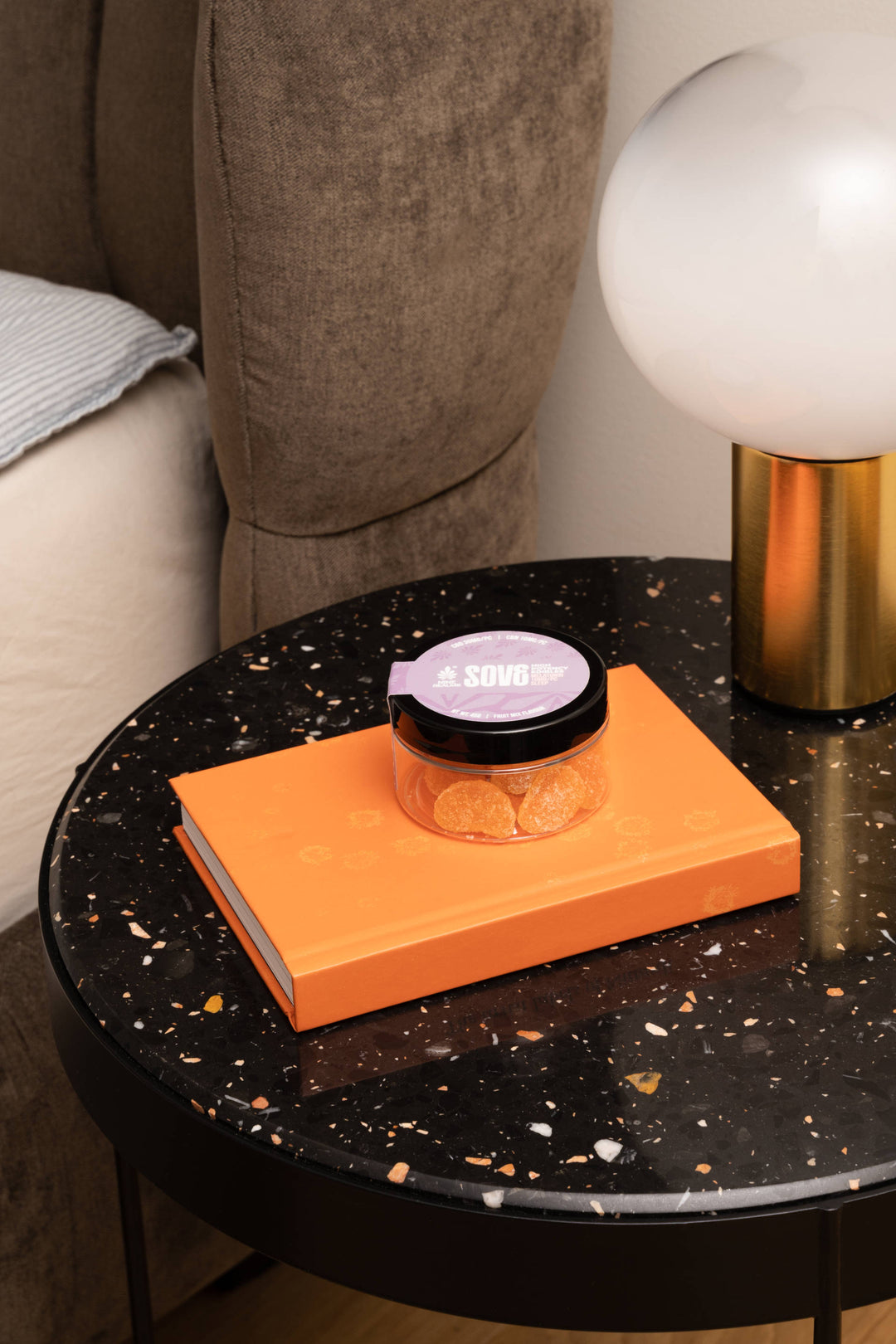 Nine Realms SOVE Edibles with CBN and Melatonin on tabletop next to bed