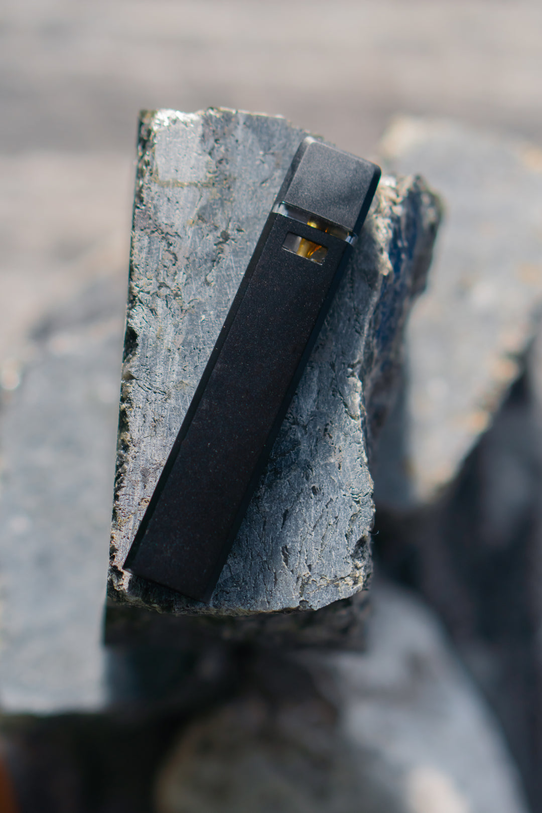 Nine Realms premium disposable vape, displayed on a natural artistic composition