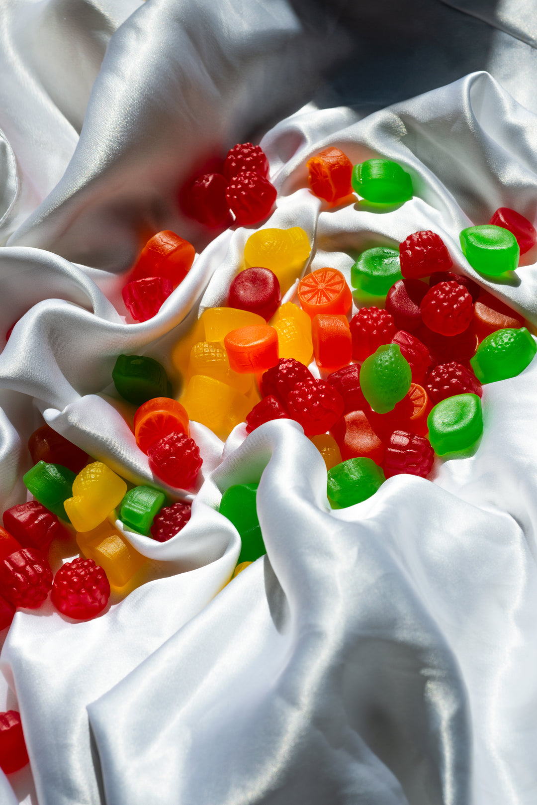 Red Green and Yellow THC Nine Realms Gummies laying on the cloth