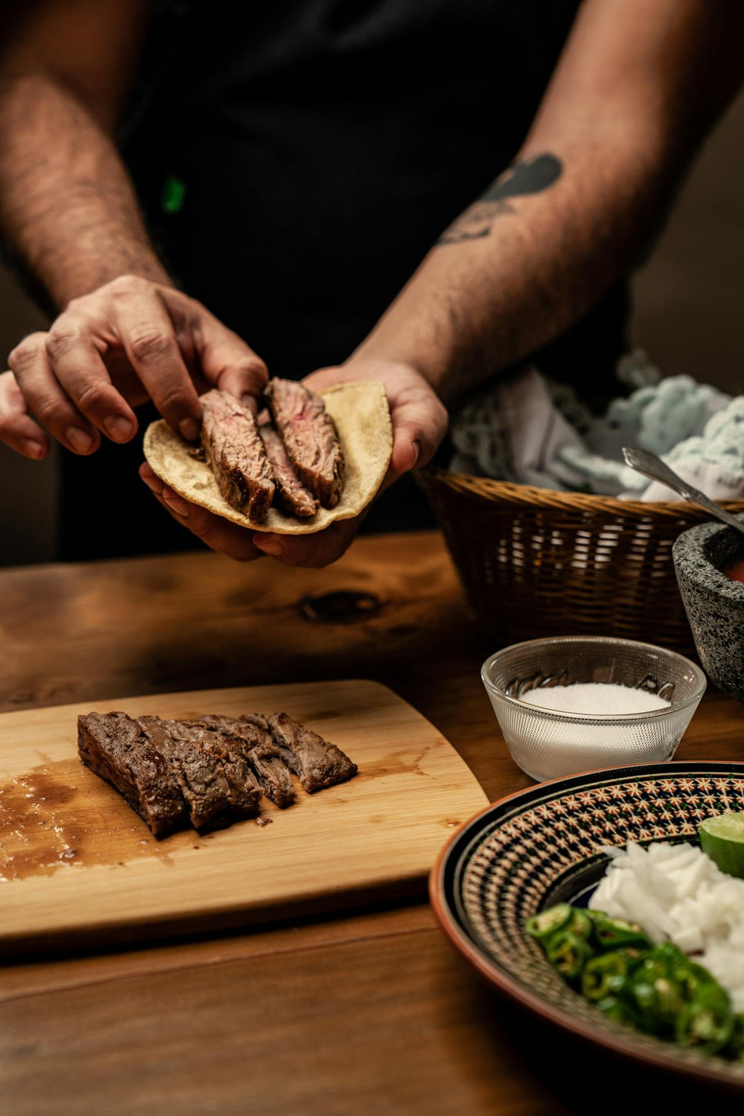 Nine realms customer eating steak with tortilla and greens