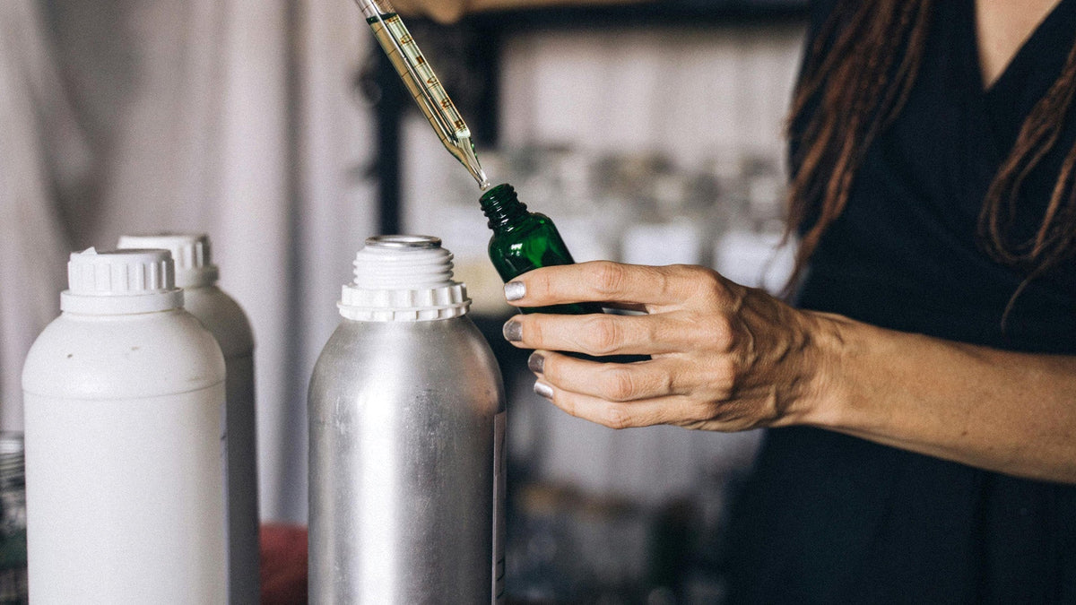 Woman taking out the Nine Realms CBG extract and filling it in a glass bottle