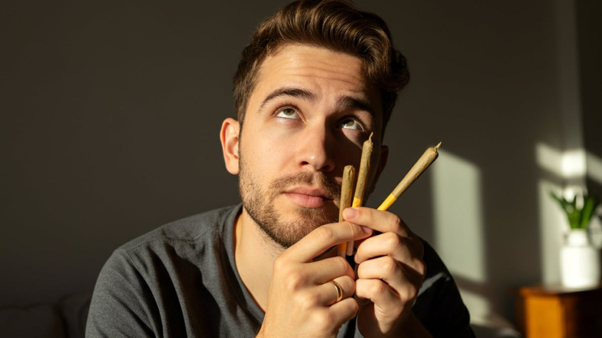 man looking at nine realms cbg and 10-oh-hhc joints