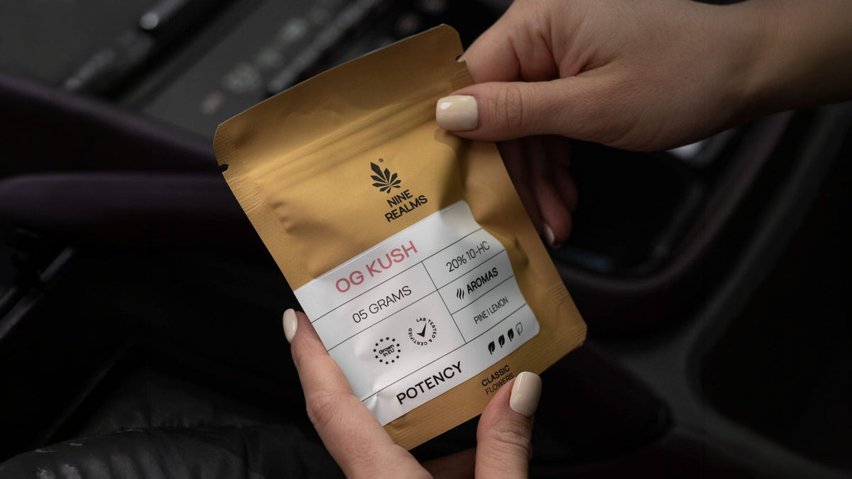 Woman holding Nine Realms OG Kush strain cannabis flower product