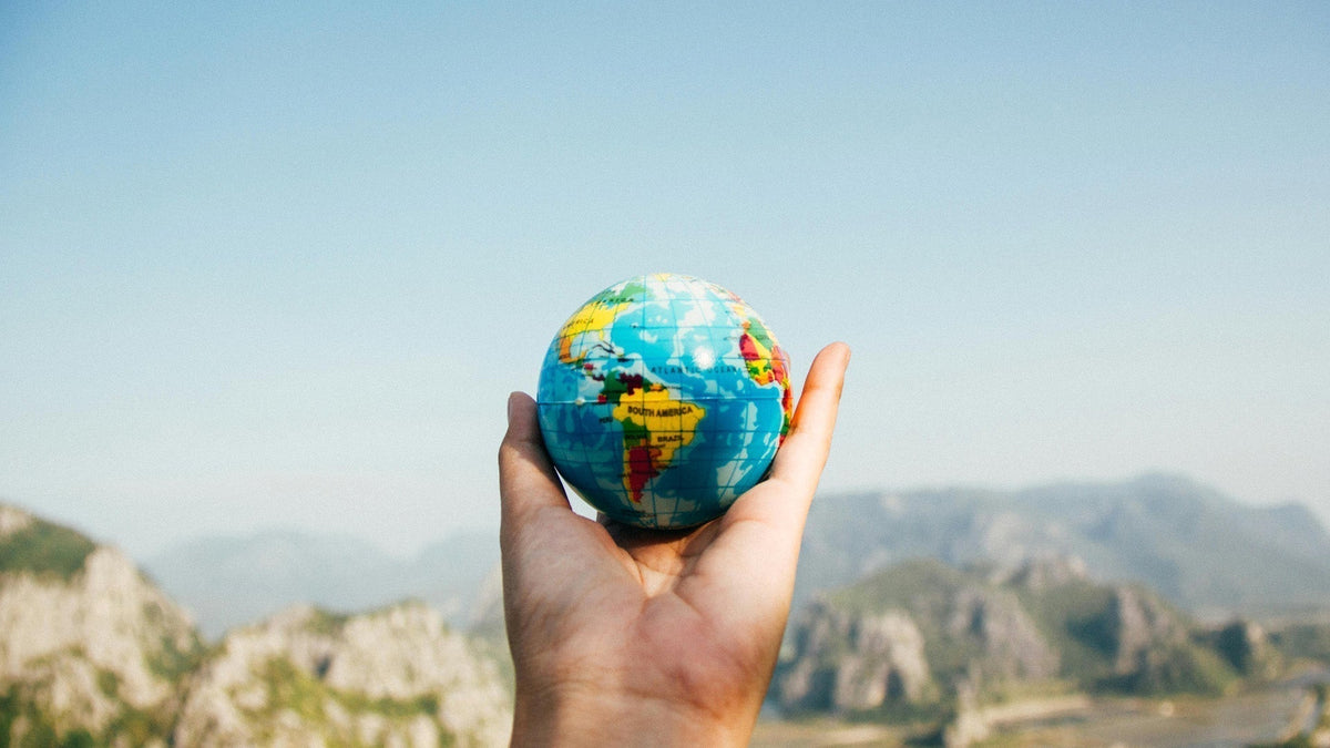 A Nine Realms customer holding a globe
