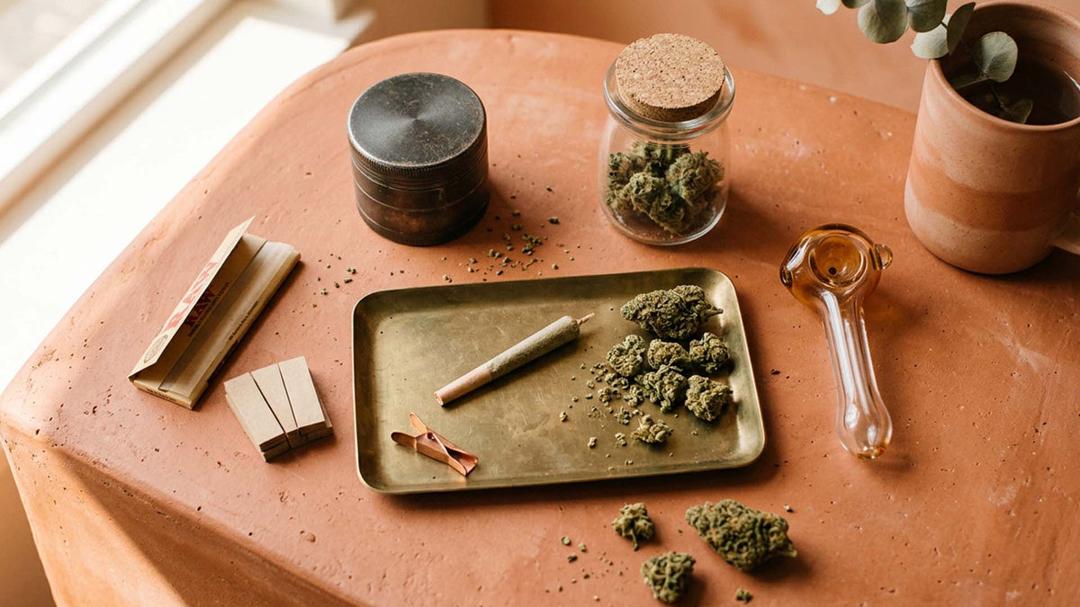 Top 5 cannabis accessories essentials on a clay table by Nine Realms