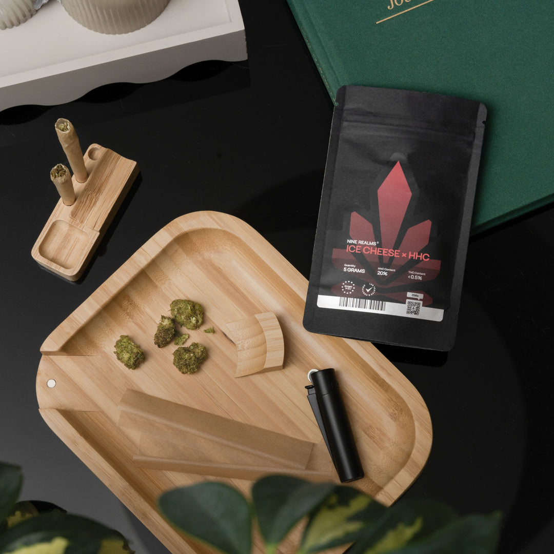 Cannabis flower buds in the rolling tray with rolling papers and lighter