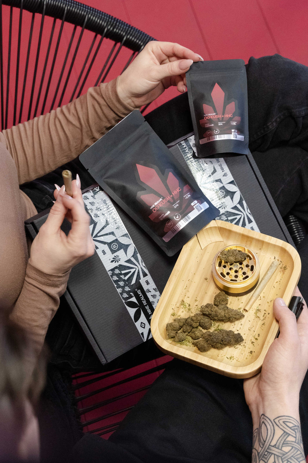 Female holding weed joint doypack with cannabis flower in the rolling tray