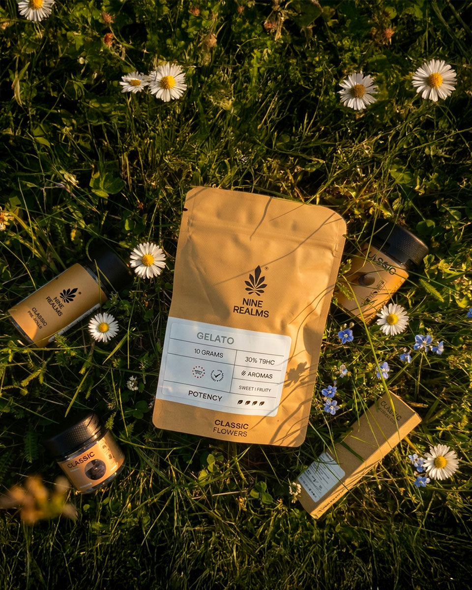 Nine Realms T9HC Cannabis products laying on the grass surrounded by field flowers