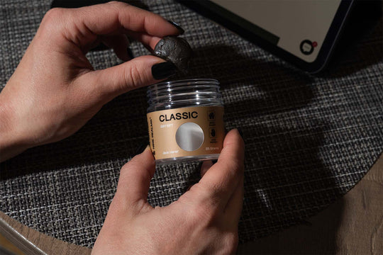 Nine Realms T9HC Dry Sift Hash on top of a dark fabric, in hands