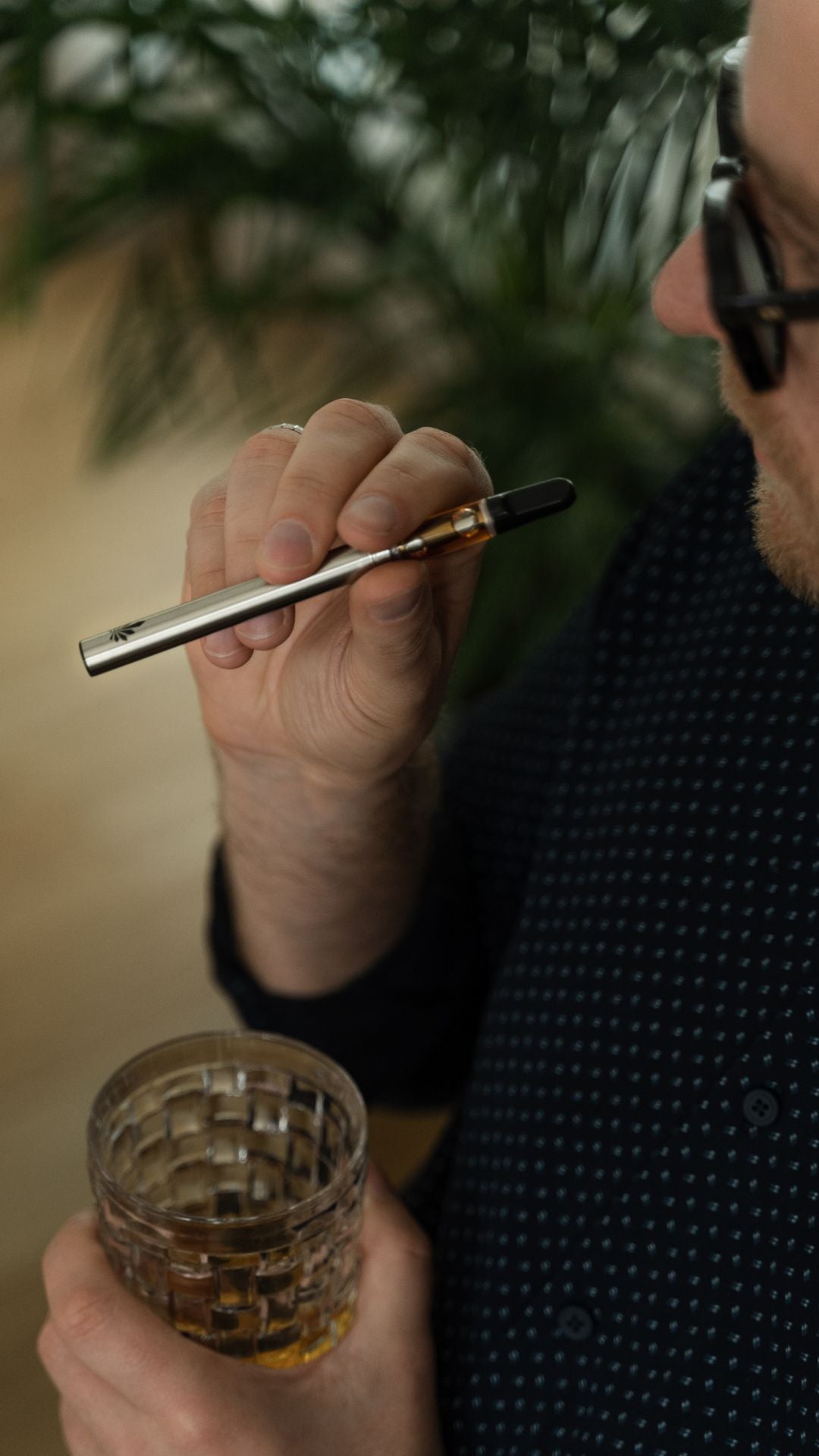 man holding a Nine Realms 10-OH-HHCP vape cartridge