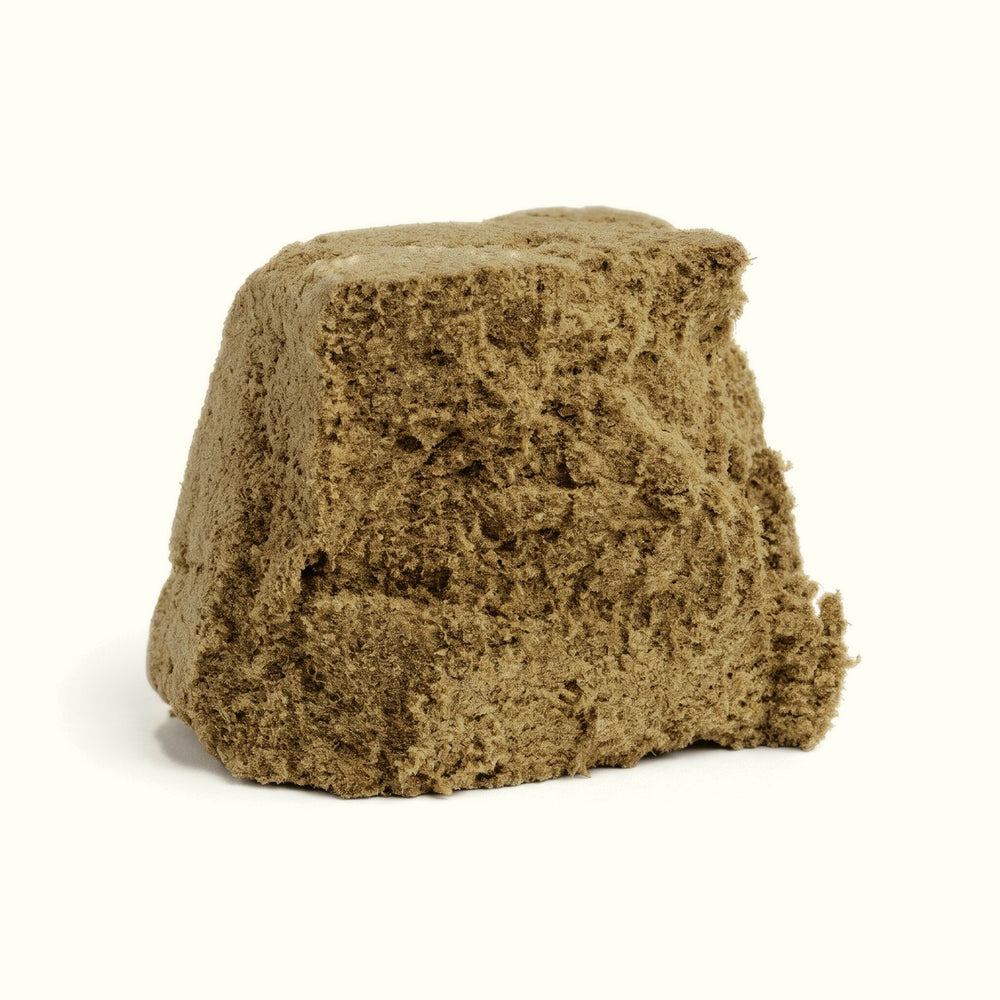 Nine Realms CLASSIC La Mousse Hash close-up: velvety, olive-brown pressed block on a cream background