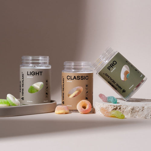 Three clear jars of Nine Realms gummies on a beige background
